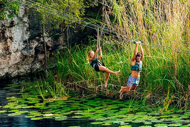 Discover and Descend on the Hidden Xenotes Tour From Cancun - K’áak’ Cenote (Fire): kayaking across sunlit water