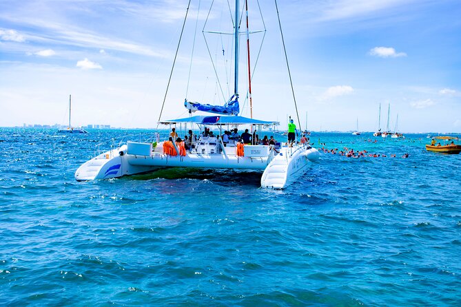 Isla Mujeres Tour on Catamaran with Snorkel, Open Bar, Buffet & Beach club - Onboard cruise vibes: games, music, and open bar energy