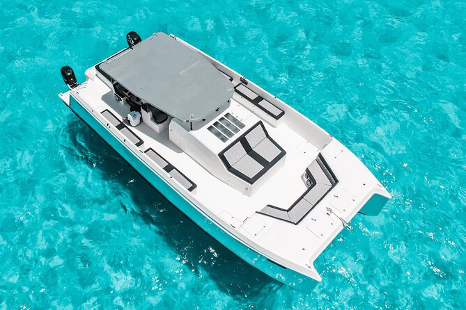 Private Atomic Catamaran Tour to Isla Mujeres - Day flow you can expect, from snack to snorkeling to beach club